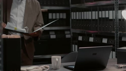 Man Reviews Files and Types on Laptop