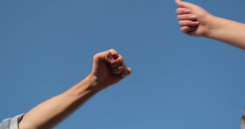 Team of People Joining Fists Together in Unity