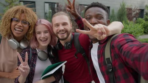 Four Smiling Friends Posing for Selfie Together