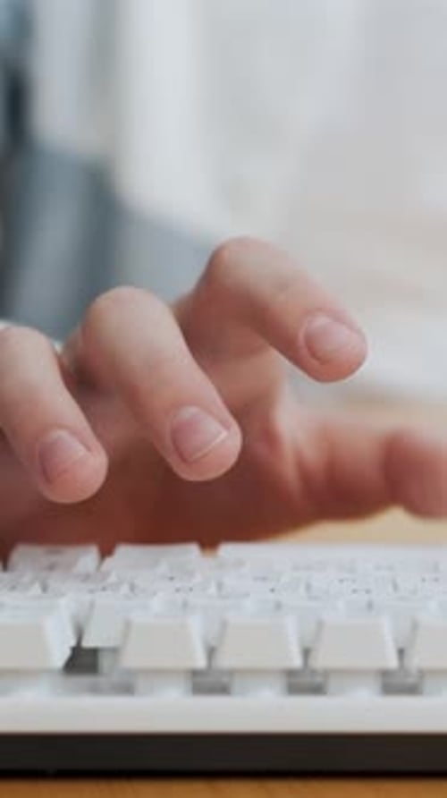 Typing on a White Computer Keyboard Close Up