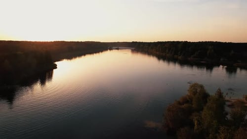 Shooting From Quadcopter of Vacationers on the White Beach of Lake Surrounded By Forest at Sunset