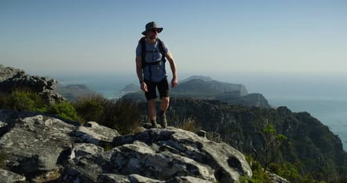 Man, hiker and exercise to explore, standing and peak, mountain top and backpack