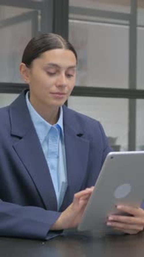 Businesswoman Using Tablet Device at Office Workplace