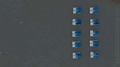 Aerial Video of Empty Sun Loungers on Cloudy Beach Day