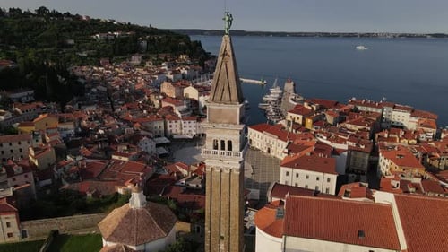 Historic seaside town with harbor. Archangel Michael statue church