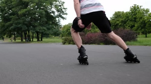 Young Man Practicing Roller Scating in Park