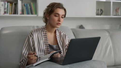 Smiling Girl Studying Home Watching Online University Class in Pajamas Closeup. Joyful