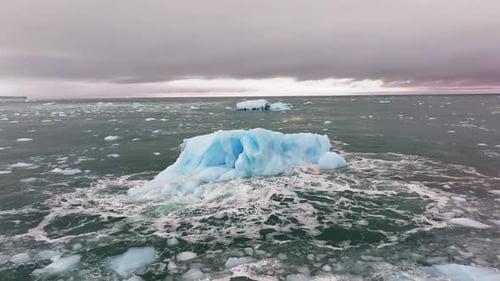 Arctic ocean Iceberg floating by the Arctic circle coastline, Aerial view