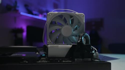 Closeup Front View of Cooling Fan of Powerful Gaming CPU Installed on Motherboard Spinning on Dark