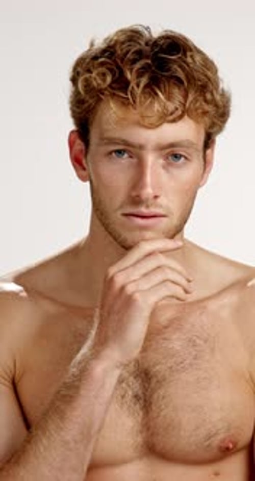 Face, skincare and smile of shirtless man in studio for masculine health, hygiene or wellness