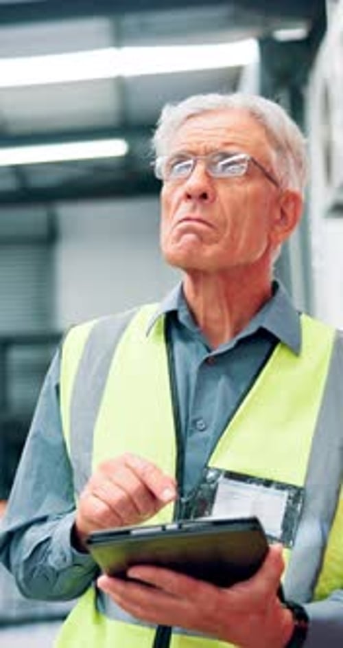 Mature man, engineer and checklist with tablet at warehouse for machine inspection and safety