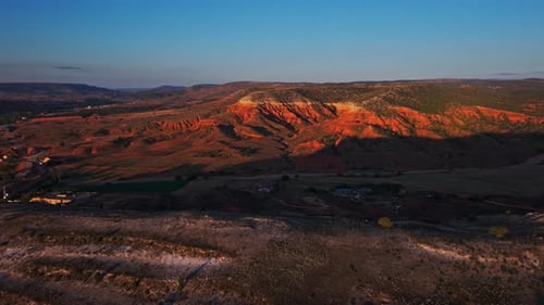Down drone shot of rocky valley during sunrise
