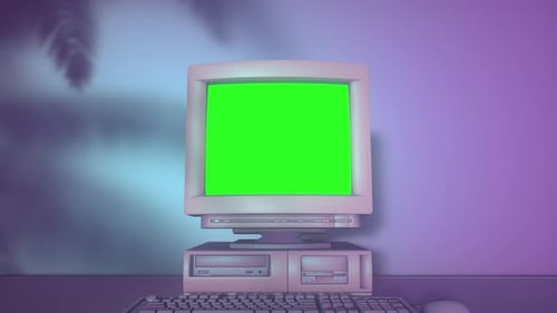 Old Personal Computer with Keyboard on a Desktop with Green Screen