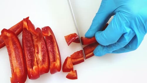Sweet Red Pepper Cutting Close Up on Kitchen Board