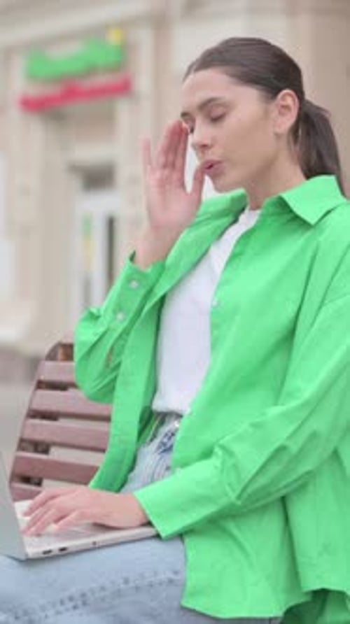 Woman Typing on Laptop, Sitting on Bench Outdoors