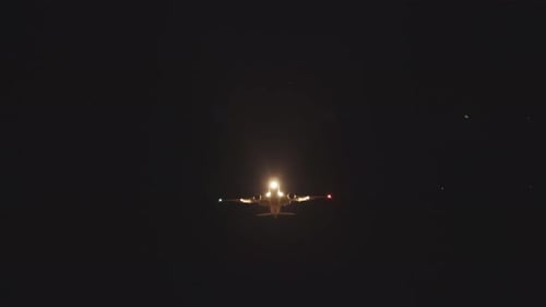 Airplane Flying Through Dark Sky