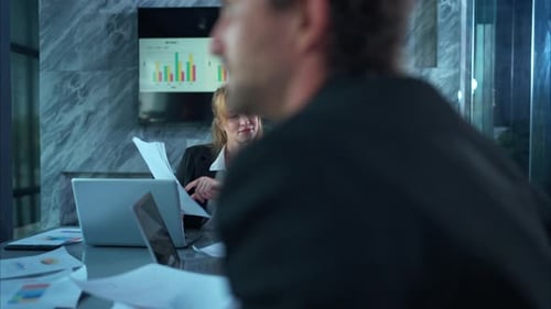 Business Colleagues Working on Financial Data in Modern Office