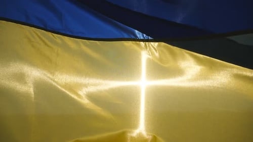 Ukrainian Flag Flowing in Wind Against Blue Sky