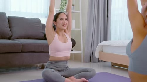 Women Exercising Together on Yoga Mats Indoors