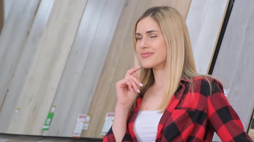 Portrait of a Beautiful Girl Who Advertises Wooden Laminate in a Construction Market