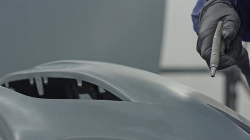 Mechanic Cleaning Auto Part in Preparation for Painting