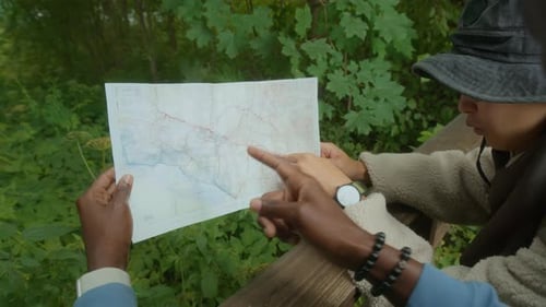 Hikers Consulting Map Outdoors in Forest