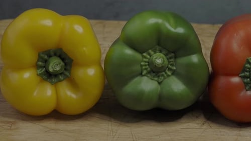 Three sweet peppers. Three colorful bell peppers red yellow and green colors in a row.
