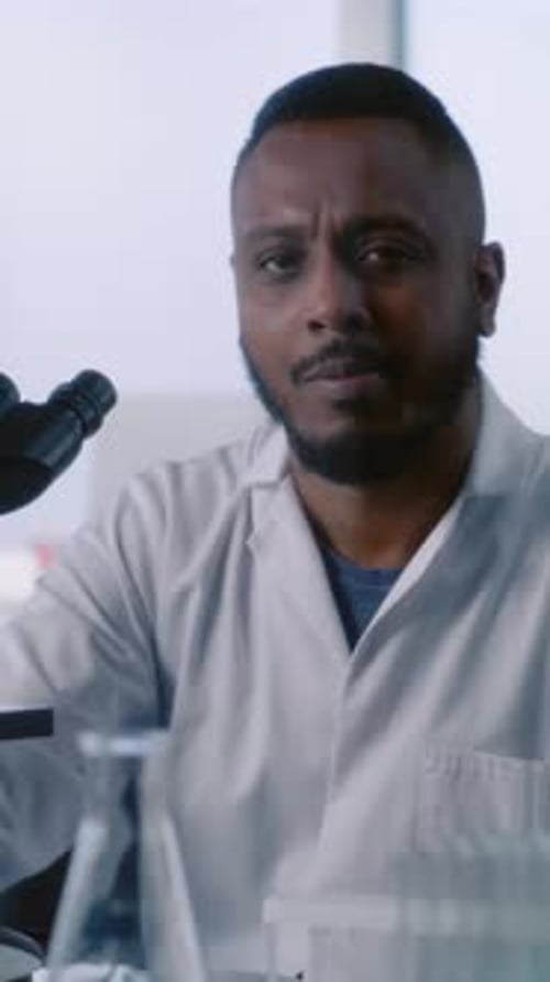 Portrait of Professional African American Microbiologist Looking at Camera