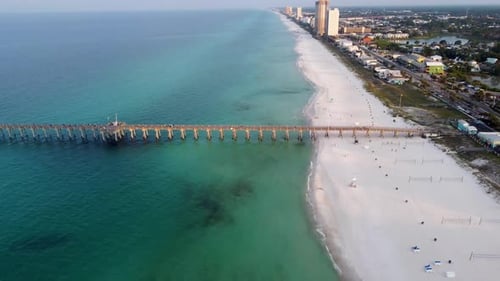 Aerial view of Fishing pier on the beach. Early morning view of beach with volleyball net on the bea