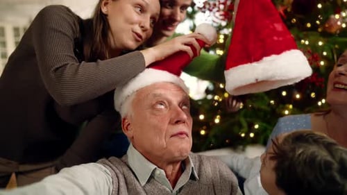 Family Celebrating Christmas with Santa Hats