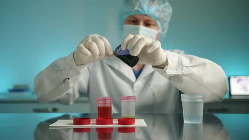Scientist Mixing Colorful Chemicals in a Lab
