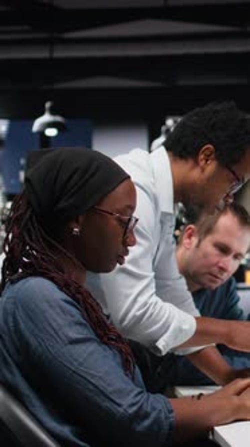 Vertical Video Engineering Team Brainstorming in Office Typing Code on Computer