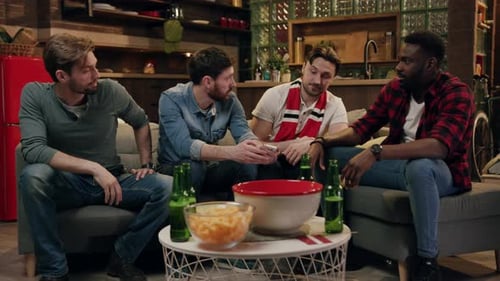 Friends Socialize Together at Home with Snacks and Beer