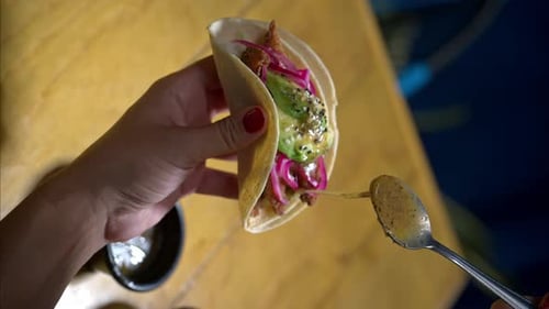 Taco Close Up Being Drizzled with Sauce