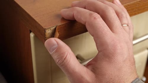 148k. The edge of the furniture plate is torn. Minor furniture repair.