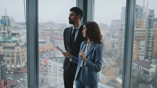 Two Company Employee Talking Work Tasks at Office Window Couple Colleagues