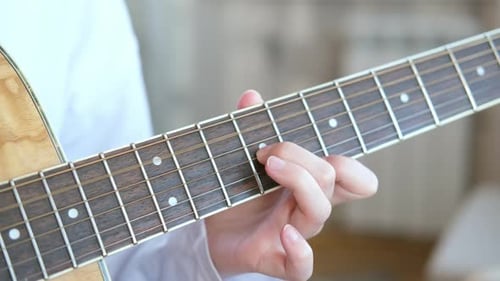 Hand is Playing the Acoustic Guitar Close Up Fingerpicking Fret Guitar Neck