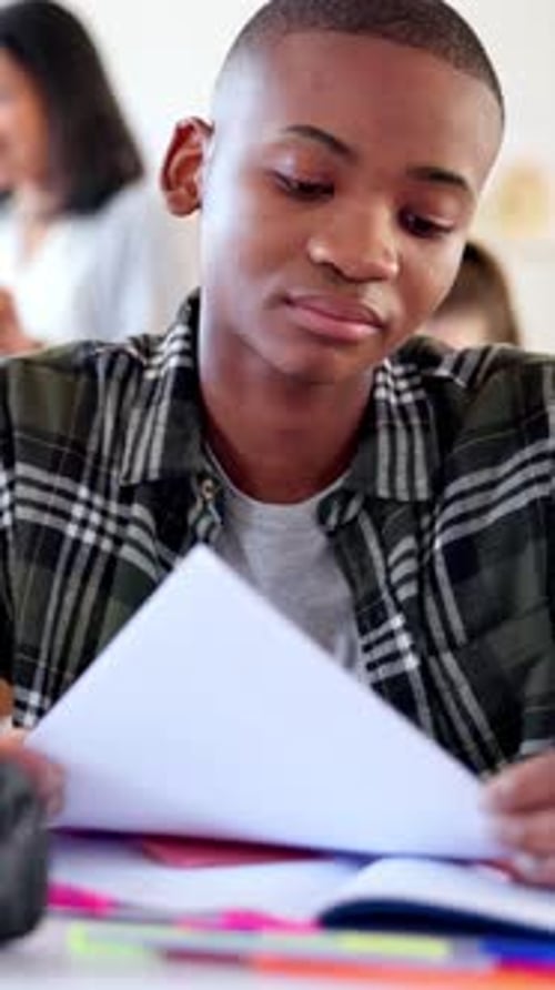 Education, paperwork and teen with worry in class, academic pressure and report with low exam marks