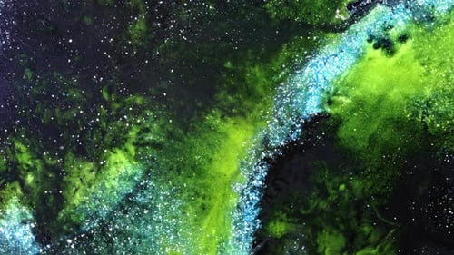 view of green and blue substances mixing in abstract and vibrant swirling motion