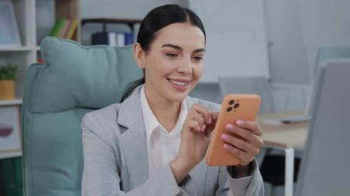 Businesswoman Looks at the Computer Screen with Fear of Terrible News While Sitting at Office