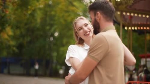 Portrait of Happy Young Couple Hugging Laughing Standing in Summer Park Carefree Chatting