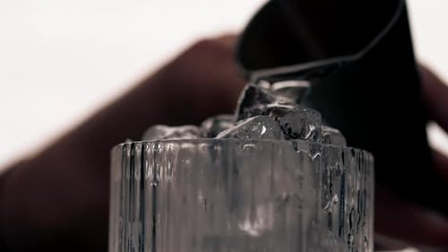 Cocktail Being Poured into Glass with Ice