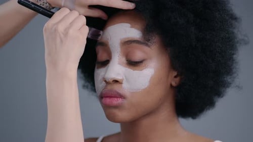 Portrait of Beautiful Tender African Girl Having Skin Care Treatment in a Salon Professional Makeup