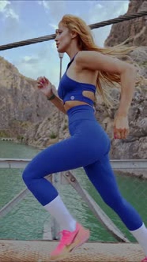 Woman Running on Suspension Bridge