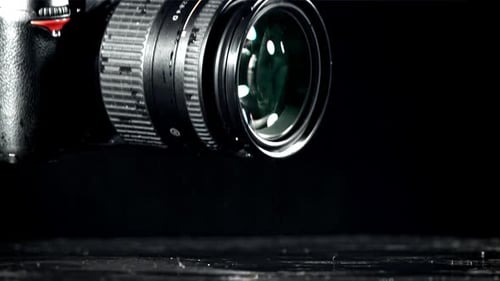 The Camera Falls with Splashes on the Wet Table Filmed on a Highspeed Camera at 1000 Fps