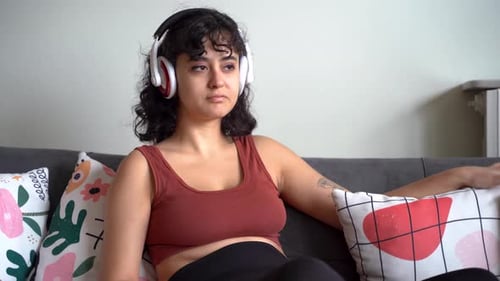 Woman Relaxing on Couch with Headphones