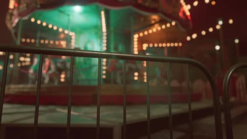 An Abandoned Amusement Park at Night with a Deserted Carousel Brightly Lit