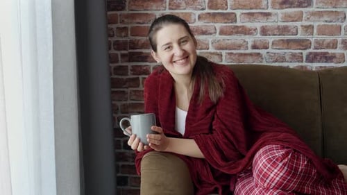 Woman Relaxing on Couch with a Mug