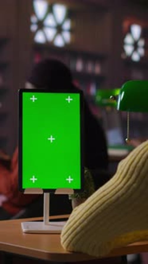 Vertical Video African American Schoolgirl Writing Class Notes Next to Chroma Key in a Library