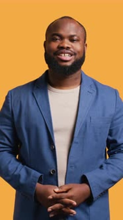 Smiling Man in Blue Blazer Poses in Studio